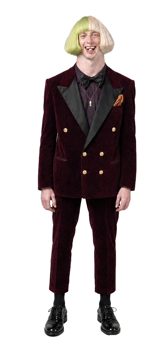 Édouard in his burgundy suit with a half-green bowl cut